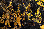 Wat Xieng Thong temple in Luang Prabang, Laos. Detail of the  intricate gold stencilling on black lacquer that decorate the walls of the sim. 